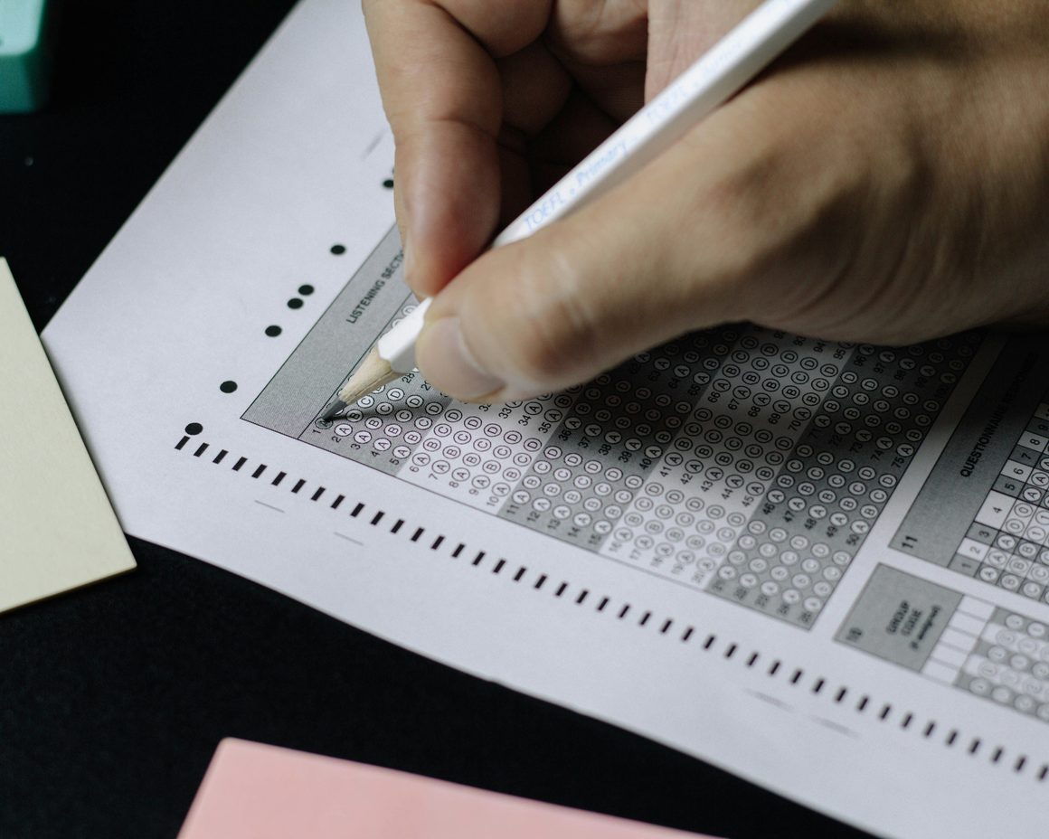 A student filling in an exam answer sheet